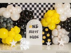 balloons and decorations are displayed in front of a black and white checkerboard backdrop