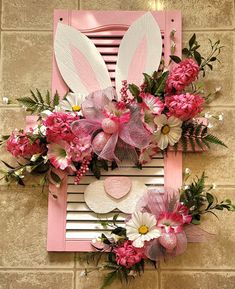 a pink frame with flowers and bunny ears on it