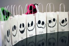 the bags have faces on them and are lined up in rows, with each bag's price tag attached