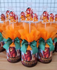 winnie the pooh cupcake toppers with orange organes and green bows on them