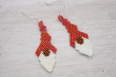 Red Holiday Gnomes, perfect for adding a fun and quirky element to your look, these earrings are sure to turn heads and spark conversations. Bead woven with delica beads one bead at a time.  Earrings measure approximately 2 inches long on Sterling Silver Ear wires. Fun and funky specialty jewelry, embrace your playful side and treat yourself to these delightful Red Gnomes earrings today!  They make a great gift or stocking stuffer. Gnomes Earrings, Holiday Gnomes, Earrings Red, Delica Beads, Brick Stitch, Bead Weaving, Stocking Stuffer, Gift For Yourself, Jewelry Handmade