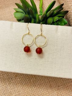 "These beautiful earrings are made with faceted orange Carnelian gemstone beads that dangle from simple gold hoops. The ear wires are hypoallergenic, gold finished brass. They hang about 1 3/4 inches. They are lightweight and a perfectly subtle way to complete your look. Need this gift wrapped? Add that here: https://www.etsy.com/jejewelry/listing/1309835402/holiday-gift-wrapping-add-on-ready-to?utm_source=Copy&utm_medium=ListingManager&utm_campaign=Share&utm_term=so.lmsm&share_time=166620147227 Round Beaded Earrings With Natural Stones As Gift, Orange Faceted Beads Jewelry For Gift, Round Natural Stones Beaded Earrings As Gift, Orange Round Faceted Beads Jewelry, Carnelian Drop Earrings Jewelry Gift, Carnelian Drop Earrings With Natural Stones, Gold Carnelian Earrings With Ear Wire, Carnelian Gold Earrings With Ear Wire, Adjustable Carnelian Earrings With Natural Stones