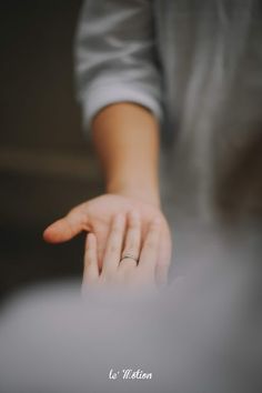 a person's hand reaching out towards something