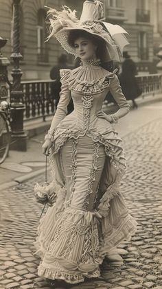 A lady dressed in an elaborate vintage gown takes a stroll down a cobbled street. Mid 19th Century Fashion, Victorian Era Womens Fashion, Cute Victorian Outfits, Turn Of The Century Fashion, 1860s Fashion Women, Modern Rococo Fashion, Elegant Vintage Outfits, Victorian Woman Aesthetic, 19th Century Fashion Women