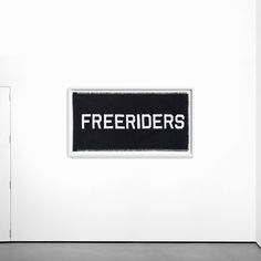 there is a sign that says freebies on the side of a white wall in an art gallery