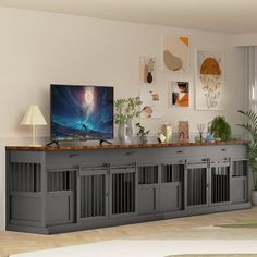 a living room filled with furniture and a flat screen tv on top of a wooden cabinet