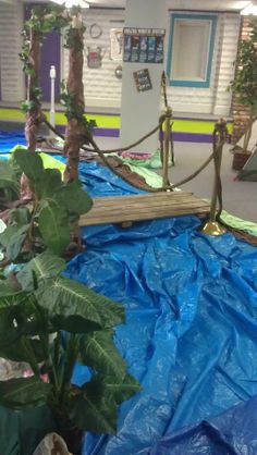 an indoor play area with ropes and plants