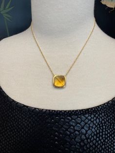 This beautiful necklace can be worn with anything, given its "gold on gold" colorway. It features a gorgeous 16.79 carat citrine square "sugarloaf" cabochon, whose rounded "sides" give the gemstone beautiful added dimension. The citrine is set in an exquisite, handmade 18k yellow bezel and is framed by a row of brilliant white diamonds. A second frame of pave set sparkling yellow sapphires echo the citrine's golden color and make this pendant stunning from all angles! The pendant measures 3/4" i Classic Yellow Gemstone Necklace, Elegant Yellow Cabochon Necklace, Elegant Yellow Faceted Necklaces, Yellow Citrine Round Pendant Necklaces, Yellow Citrine Pendant Necklace, Ruby Sapphire, Ring Pendant Necklace, Yellow Sapphire, Beautiful Necklace