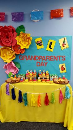 a yellow table topped with lots of tassels next to a sign that says grandparents's day