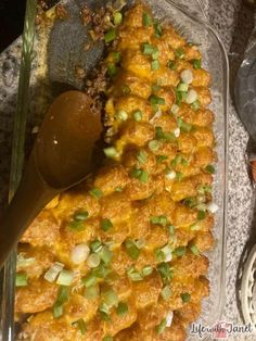 a casserole dish with green onions and cheese