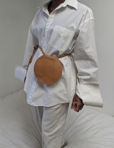 A circular folding bag with a rolled shoulder strap for tying in a bow or knot, two interior slit pockets, and magnet closure.  A bag just your essentials! Can be worn over the shoulder, around the waist, or on the arm. Folding Bag, Knit Outerwear, Longchamp Le Pliage Backpack, Line Shopping, Knit Cotton, Toddler Dress, Tan Color, A Bag, Vintage Accessories