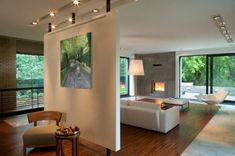 a living room filled with furniture and a fire place in the middle of it's walls