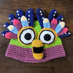 a crocheted hat with an image of a bird's head on it