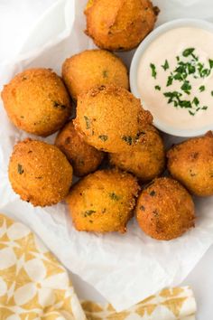 some fried food is on a plate with a small bowl of ranch dressing next to it