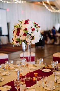 the table is set with flowers and desserts