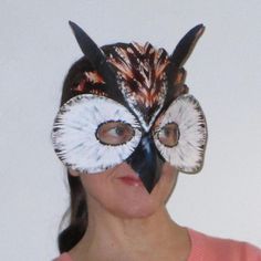 a woman with an owl mask on her face