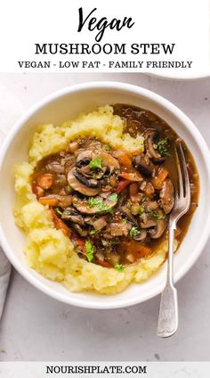 a white bowl filled with mashed potatoes and mushroom stew on top of a table