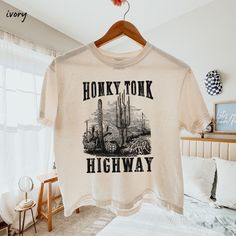 Honky Tonk Shirt, Nashville Honky Tonk Tee, Country Music Shirt, Desert Highway Tee, Vintage Cowgirl Shirt, Vintage Western Tee Southern Tee Comfort Colors® Boxy Tee This women's oversized boxy t-shirt brings ample comfort and a laidback style that feels right at home in any occasion. With its 100% ring-spun cotton fabric, it feels soft, while the boxy fit with the slightly cropped, seamless body adds that signature oversized look. Comfort Colors is a proud member of the US Cotton Trust protocol Band Merch Cotton Top With Funny Print, Music-themed Cotton Top With Graphic Print, Music-themed Cotton Tops With Graphic Print, Music-themed Cotton Top With Text Print, Music-themed Cotton Graphic Top, Funny Print Crew Neck Tops For Concerts, Music-themed Cotton Tops With Crew Neck, Music-themed Cotton Crew Neck Top, Band Merch Tops With Funny Print For Concerts