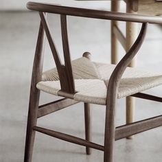 a wooden chair sitting on top of a cement floor