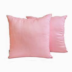 two pink pillows sitting next to each other