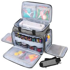 an open suitcase with various items inside it on a white surface, including pens and markers