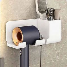 a wall mounted hair dryer and brush holder