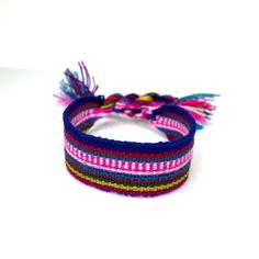 Woven Friendship Bracelet, Multicolor, Colorful, Striped Bracelet, Minimalist Bracelet, Perfect Small Gift, Boho, Textile, Matching Bracelets ❋ details: • Bracelet Length: 26 cm. • Bracelet Width: 2.5 cm. • Blue borders and stripes woven in Purple, Red, Blue, Pink, White, Yellow, and Green. • Softly woven wide bracelet, that lays flat on your wrist and is secured by the tie-on ties. • 100% Handmade in Ecuador • Dainty and unique perfect to gift! Hippie Pink Bracelet For Gift, Hippie Pink Bracelet As Gift, Pink Hippie Bracelet For Gift, Traditional Adjustable Purple Bracelets, Traditional Adjustable Purple Bracelet, Handmade Adjustable Multicolor Wristlet, Colorful Adjustable Traditional Bracelets, Hippie Woven Gift Bracelets, Handmade Multicolor Friendship Wristband