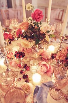 a table topped with lots of candles and flowers