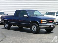 a blue truck is parked in a parking lot