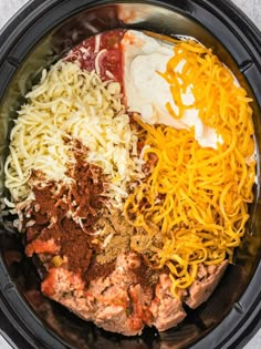 an image of food in the crock pot with cheese and other ingredients to make it