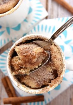 two mugs filled with hot chocolate and cinnamon