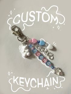 keychain with custom name and charms attached to it's side on a white background