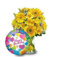 a vase filled with yellow flowers next to a happy birthday card and balloon in it