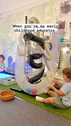 two children playing with toys in a play room