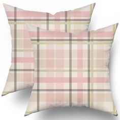 two pink and green plaid pillows sitting on top of eachother in front of a white background