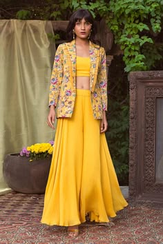 Yellow blazer with printed floral motifs. Comes with flared pant and crop top.
Components:3
Neckline:Top: Scoop; Blazer: Lapel
Sleeve Length:Blazer: Bracelet
Fabric:Crepe, Organza
Color:Yellow
Pleated detail on blazer lapel - Aza Fashions Plazo Outfits, Crop Top Outfits Indian, Crop Top Palazzo, Haldi Outfits, Western Dresses For Women, Organza Suits, Trendy Outfits Indian, Blazer Outfits For Women, Yellow Blazer