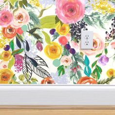 a painting with flowers on the wall and a light switch plate in front of it