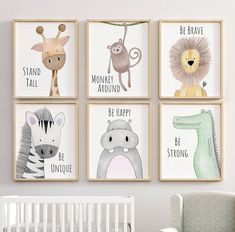 four children's wall art prints with animals and words on them, hanging in a nursery