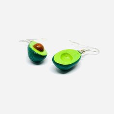 Inspired by the vibrant culture and art of Mexico, these Avocado Clay Earrings are a must-have for any fashion-forward individual. Hand-crafted by skilled artisans, each intricate design showcases the beauty of traditional Mexican jewels. Indulge in the delicious combination of mini realistic drops and dangle earrings that radiate natural charm and elegance. Perfect for summer fashion, these earrings are a unique and memorable gift that will be cherished and worn with pride. Gift-ready, these ea Traditional Hypoallergenic Drop Earrings, Unique Earrings For Festivals Gift, Teardrop Danglers For Gift, Single Plug Earring As Festival Gift, Artisan Green Drop Earrings, Artisan Green Pierced Jewelry, Artisan Green Jewelry For Pierced Ears, Artisan Teardrop Earrings As Gift, Green Hoop Earrings For Festivals And Gifts