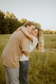 a man hugging a woman in a field