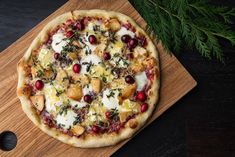 a pizza sitting on top of a wooden cutting board