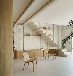 an empty room with two chairs and a potted plant