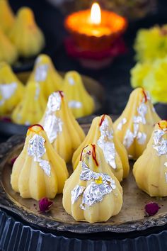 small desserts on a plate with candles in the background