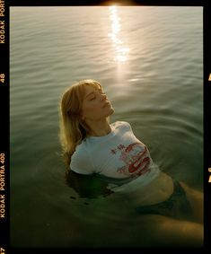 a woman floating on top of a body of water