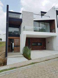 a modern house with wood and glass on the front