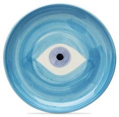 a blue and white bowl with an eye in the center