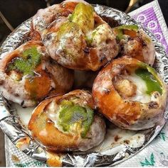 there are many different types of pastries on the plate and one is covered in green sauce