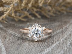 a diamond ring sitting on top of a piece of wood