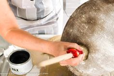 a person using a rolling pin to make dough