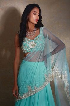 Tiffany blue lehenga saree featuring a tiered design with bead tassels and an attached sheer drape. Highlighted by gradient sequin bead embellishments, it comes with a matching embellished camellia patterned blouse., Fit: Relaxed Fitted Blue Pre-draped Saree For Transitional Season, Blue Draped Lehenga For Wedding, Blue Draped Choli For Reception, Draped Blue Choli For Reception, Fitted Draped Anarkali Traditional Wear, Fitted Anarkali Traditional Wear, Embellished Draped Dupatta For Wedding, Blue Fitted Pre-draped Saree For Transitional Season, Blue Draped Lehenga With Dupatta